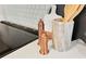 Close up of kitchen counter with copper salt and pepper shakers, marble utensil holder and white countertop at 6087 S Elizabeth Way, Centennial, CO 80121