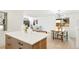 Open living area with a modern light fixture, a wooden dining table and chairs, and a kitchen island at 6087 S Elizabeth Way, Centennial, CO 80121