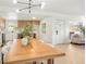 An open floor plan shows the bright kitchen, dining area with modern lighting, and door to the backyard at 6087 S Elizabeth Way, Centennial, CO 80121