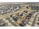 Wide aerial shot of a meticulously planned suburban neighborhood with winding roads and lush green spaces at 27234 E Quarto Ave, Aurora, CO 80016