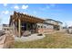 Inviting outdoor patio featuring seating and a grill, with a pergola and manicured lawn at 27234 E Quarto Ave, Aurora, CO 80016