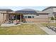 Spacious backyard with solar panels, patio area, seating, and lush landscaping perfect for outdoor living at 27234 E Quarto Ave, Aurora, CO 80016