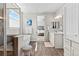 Bright bathroom featuring a soaking tub, separate glass shower, and double vanities with marble countertops at 27234 E Quarto Ave, Aurora, CO 80016