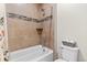 Well-lit bathroom featuring a shower-tub combination with tiled surround, offering a clean and functional space at 27234 E Quarto Ave, Aurora, CO 80016