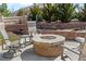 Cozy backyard fire pit with stone seating and professional landscaping for relaxing outdoor gatherings at 27234 E Quarto Ave, Aurora, CO 80016