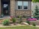 Inviting front yard features a stone facade and landscaped flower bed at 27234 E Quarto Ave, Aurora, CO 80016
