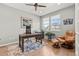 Comfortable home office featuring wood floors, ample natural light, and a relaxing sitting area at 27234 E Quarto Ave, Aurora, CO 80016