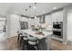 Modern kitchen with island, stainless appliances, pendant lighting, and seating for four at 27234 E Quarto Ave, Aurora, CO 80016