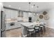 Open concept kitchen with island, stainless appliances, pendant lighting, and seating for four at 27234 E Quarto Ave, Aurora, CO 80016