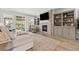 Bright living room featuring built-in shelves, a fireplace, and plenty of natural light at 27234 E Quarto Ave, Aurora, CO 80016