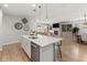 View of open concept, with modern kitchen, dining area, and living room with fireplace at 27234 E Quarto Ave, Aurora, CO 80016