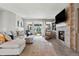 Bright living room with comfortable seating, fireplace, TV, and sliding doors to outdoor space at 27234 E Quarto Ave, Aurora, CO 80016