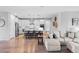Modern open-concept living space with a spacious seating area and a kitchen island with bar stool seating at 27234 E Quarto Ave, Aurora, CO 80016