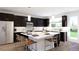 Modern kitchen with a large island, stainless steel appliances, and dark cabinetry at 3877 Bahn Ct, Evergreen, CO 80439