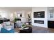 Bright living room featuring a modern fireplace, TV, neutral furniture, and contemporary decor at 3877 Bahn Ct, Evergreen, CO 80439