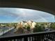 Beautiful balcony view overlooking a rainbow arching over a residential complex and lush greenery at 18989 E Warren Dr # G303, Aurora, CO 80013