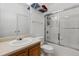 Bright, clean bathroom featuring a shower with glass doors and a sink with cabinet at 18989 E Warren Dr # G303, Aurora, CO 80013