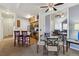 Open dining area featuring glass table, wood flooring, and a large mirror reflecting the living room at 18989 E Warren Dr # G303, Aurora, CO 80013