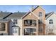 Close up view of a stone accented condo building with private balconies and detailed facade at 18989 E Warren Dr # G303, Aurora, CO 80013