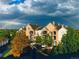Beautiful exterior view of condo buildings with manicured landscaping and a bright rainbow overhead at 18989 E Warren Dr # G303, Aurora, CO 80013