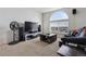 Carpeted living room featuring a large arched window that lets in ample natural light at 18989 E Warren Dr # G303, Aurora, CO 80013