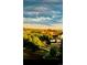 Scenic neighborhood view with tree-lined streets and well-maintained houses under a bright sky at 18989 E Warren Dr # G303, Aurora, CO 80013