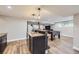 Spacious basement with a wet bar, custom cabinets, a foosball table and wood-look flooring at 10397 Yates Ct, Westminster, CO 80031