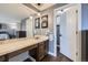 Primary bathroom with warm-toned vanity, mirror, and an ensuite at 10397 Yates Ct, Westminster, CO 80031