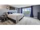 Comfortable bedroom with carpet flooring, a queen bed, and a large window at 10397 Yates Ct, Westminster, CO 80031