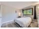 Cozy bedroom featuring a white metal frame bed, soft carpet, and an ambient vanity area at 10397 Yates Ct, Westminster, CO 80031