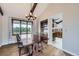 This dining room features hardwood flooring, exposed beams, and an elegant light fixture at 10397 Yates Ct, Westminster, CO 80031