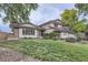 Charming two-story home boasts a beautiful lawn and complemented by lush trees in the background at 10397 Yates Ct, Westminster, CO 80031