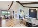 This open-concept living area has high ceilings, exposed beams, and hardwood flooring at 10397 Yates Ct, Westminster, CO 80031