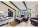 Inviting living room featuring exposed beams, large windows, and hardwood floors at 10397 Yates Ct, Westminster, CO 80031