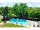 Inviting community pool surrounded by lush landscaping and comfortable lounge chairs on a sunny day at 10397 Yates Ct, Westminster, CO 80031