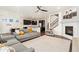 Open-concept living room featuring a fireplace, hardwood floors, and view of the kitchen at 19316 W 84Th Pl, Arvada, CO 80007