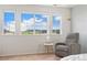 Light-filled bedroom featuring a comfortable chair and bright windows at 19316 W 84Th Pl, Arvada, CO 80007