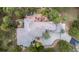 Aerial view of the home highlighting the roofline, deck, patio, landscaping, and surrounding trees at 22554 Treetop Ln, Golden, CO 80401