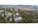 Aerial view of a multi-home community nestled in a wooded area, showcasing mountain views at 22554 Treetop Ln, Golden, CO 80401
