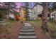 Stairs lead to the backyard of this multi-story home, which is surrounded by mature trees at 22554 Treetop Ln, Golden, CO 80401