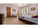 Comfortable bedroom with a colorful bedspread and natural light from large windows at 22554 Treetop Ln, Golden, CO 80401