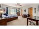 Bright bedroom with a ceiling fan, a work station, and casual seating area at 22554 Treetop Ln, Golden, CO 80401