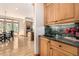 Cozy butler's pantry featuring granite countertops, wooden cabinets, and a convenient under-cabinet sink at 22554 Treetop Ln, Golden, CO 80401
