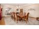 Elegant dining room featuring a large wooden table with seating for ten, fireplace, and chandelier at 22554 Treetop Ln, Golden, CO 80401