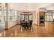 Dining room features hardwood floors and abundant natural light and view into kitchen with stainless appliances at 22554 Treetop Ln, Golden, CO 80401