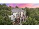 Stunning exterior view of a multi-story home with a large deck and surrounding mature trees at 22554 Treetop Ln, Golden, CO 80401