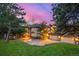 Beautiful home exterior with stone and stucco, three-car garage, manicured lawn, and mature landscaping at 22554 Treetop Ln, Golden, CO 80401