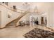 Spacious foyer featuring a curved staircase, light tile flooring, and ample natural light at 22554 Treetop Ln, Golden, CO 80401