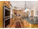 Spacious kitchen features stainless steel appliances, granite countertops, and ample wood cabinetry at 22554 Treetop Ln, Golden, CO 80401