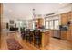Spacious kitchen with wood cabinets, a center island, and open access to living area at 22554 Treetop Ln, Golden, CO 80401